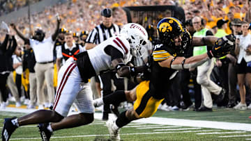 DUPLICATE***Iowa Hawkeyes wide receiver Kaden Wetjen (21) dives into the endzone to score as Massachusetts Minutemen safety DD Snyder (4) defends Sept. 13, 2025 at Kinnick Stadium in Iowa City, Iowa.