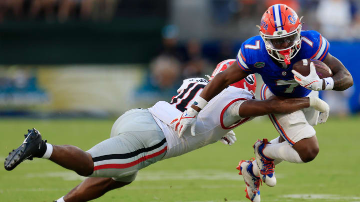 Georgia Bulldogs linebacker Jamon Dumas-Johnson (10) tackles Florida Gators running back Trevor Etienne (7) during the third quarter of an NCAA Football game Saturday, Oct. 28, 2023 at EverBank Stadium in Jacksonville, Fla. Georgia defeated Florida 43-20.