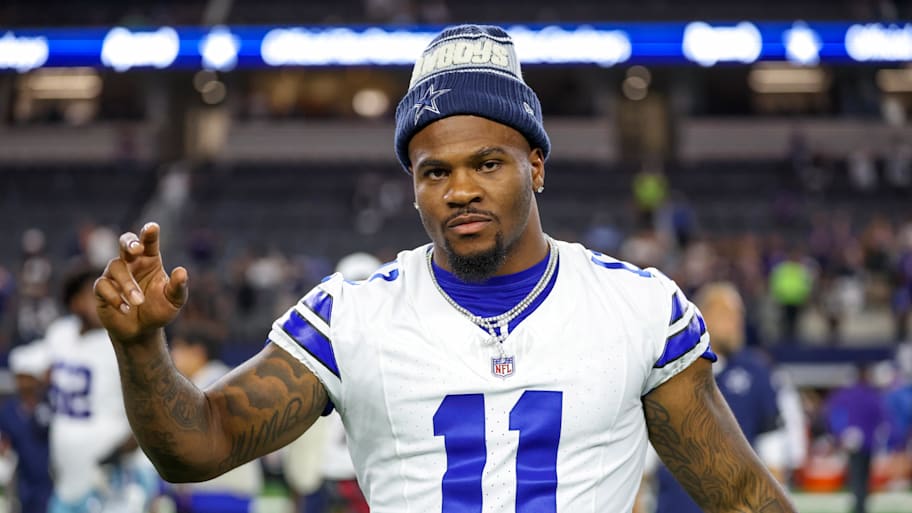 Micah Parsons waves while wearing a Cowboys jersey and hat