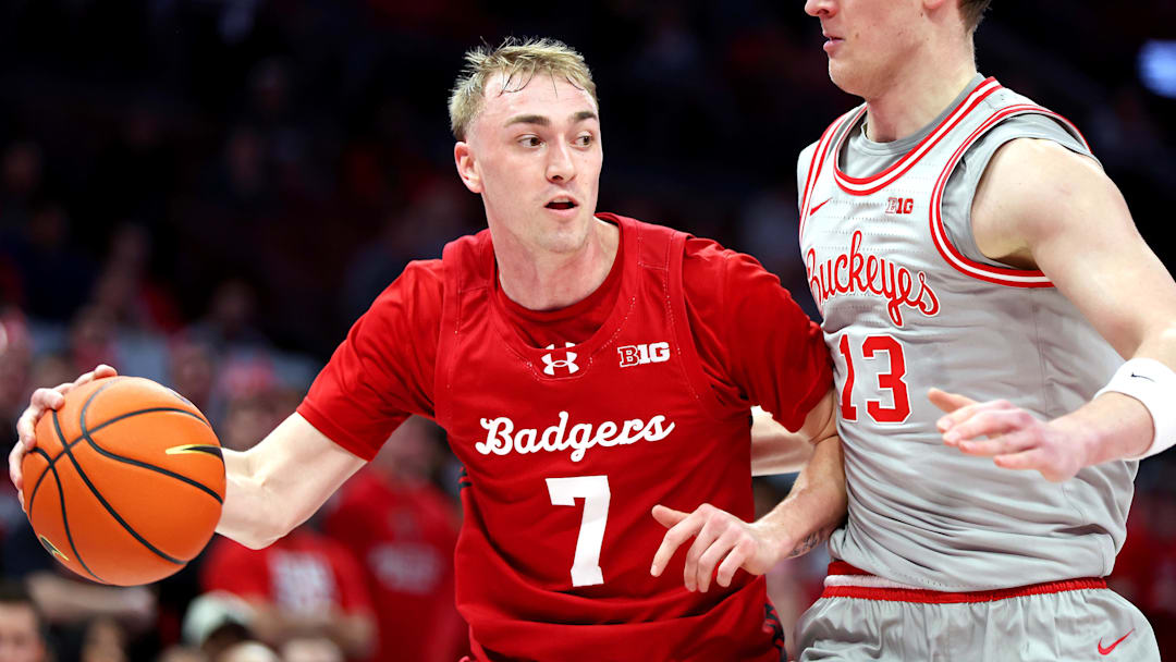 Feb 17, 2026; Columbus, Ohio, USA; Wisconsin Badgers guard Andrew Rohde (7) looks to pass the ball as Ohio State Buckeyes center Christoph Tilly (13) defends during the first half at Value City Arena. Mandatory Credit: Joseph Maiorana-Imagn Images