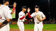 Roman Anthony high fives WooSox teammates following the Triple-A club's 12-2 win over Toledo on Tuesday at Polar Park.