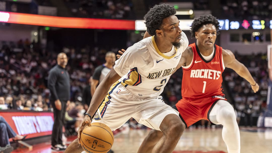 Oct 14, 2025; Birmingham, Alabama, USA; New Orleans Pelicans forward Herb Jones (2) works past Houston Rockets guard-forward Amen Thompson (1) during an NBA preseason game at Legacy Arena at BJCC. Mandatory Credit: Vasha Hunt-Imagn Images
