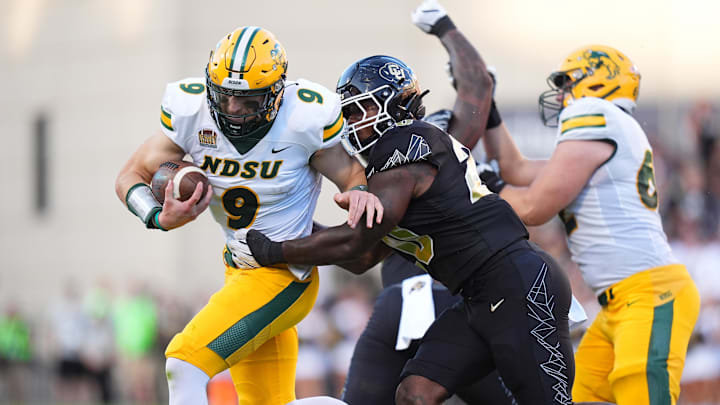Aug 29, 2024; Boulder, Colorado, USA; Colorado Buffaloes linebacker LaVonta Bentley (20) tackles North Dakota State Bison quarterback Cole Payton (9) in the first half at Folsom Field. Mandatory Credit: Ron Chenoy-Imagn Images