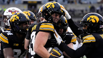 Teammates congratulate Iowa Hawkeyes linebacker Cam Buffington (33) after he intercepted a pass during a game against the Minnesota Golden Gophers Oct. 25, 2025 at Kinnick Stadium in Iowa City, Iowa.