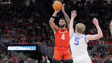Illinois guard Kylan Boswell (4) hits a three-point basket over Kentucky guard Collin Chandler (5) during the second half of their second round NCAA men’ s basketball tournament game Sunday, March 23, 2025 at Fiserv Forum in Milwaukee, Wisconsin. Kentucky beat Illinois 84-75.