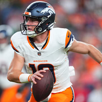 Aug 18, 2024; Denver, Colorado, USA; Denver Broncos quarterback Bo Nix (10) scrambles with the ball in the first quarter against the Green Bay Packers at Empower Field at Mile High. 