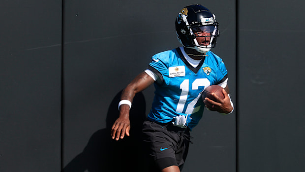 Jacksonville Jaguars wide receiver Travis Hunter (12) hits the padded wall after a sucessful reception during the second mand