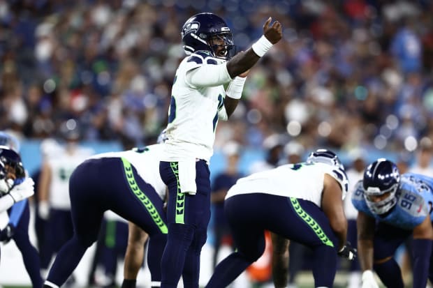 Seattle Seahawks quarterback PJ Walker (15) signals a change.