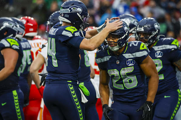 Seattle Seahawks running back Zach Charbonnet celebrates with quarterback Sam Darnold