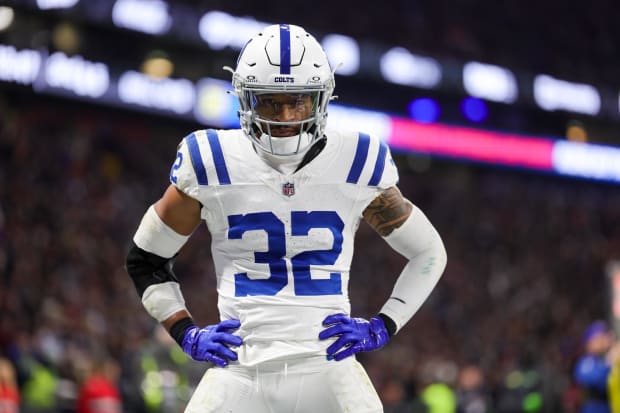 Football player Julian Blackmon reacts after a play in a white jersey.