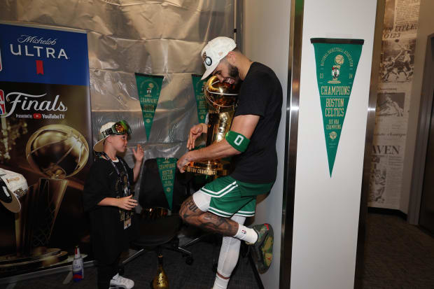 Boston Celtics forward Jayson Tatum (0) holds the Larry O’Brien Championship Trophy after winning the 2024 NBA Finals.