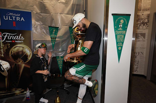 Boston Celtics star Jayson Tatum holds the Larry O’Brien Trophy after the Celtics won the 2024 NBA championship.