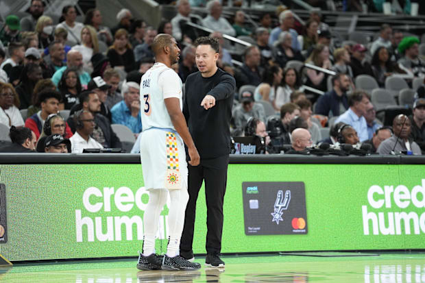 San Antonio Spurs acting head coach Mitch Johnson talks with guard Chris Paul (3) during the first half against the Atlanta Hawks.