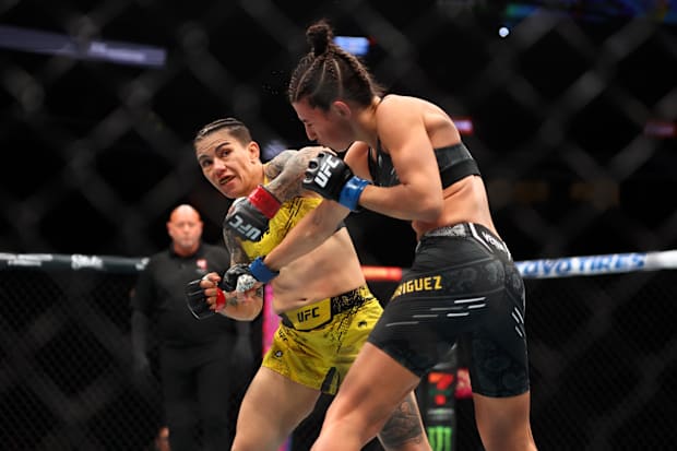 Jessica Andrade (red gloves) fights Marina Rodriguez (blue gloves) during UFC 300 at T-Mobile Arena. 