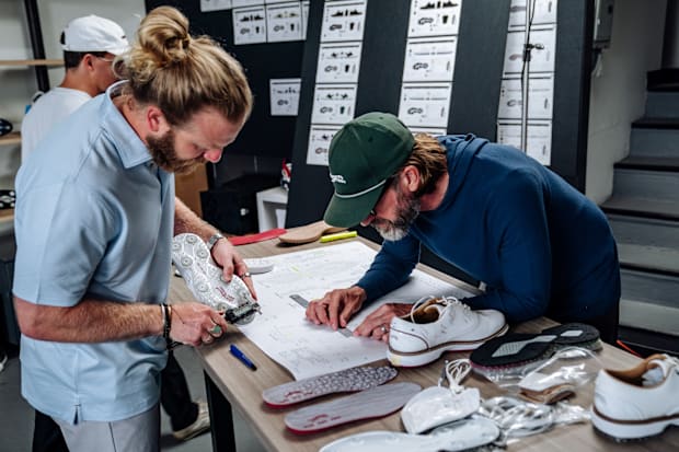 Charley Hudak words on Tiger Woods' golf shoes.