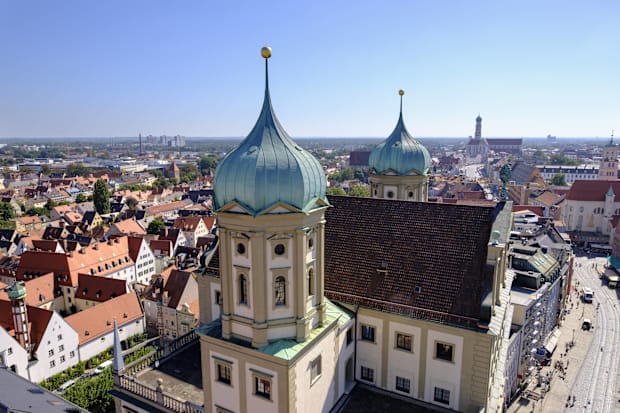 Staying in Augsburg would be cheaper than staying in Munich.