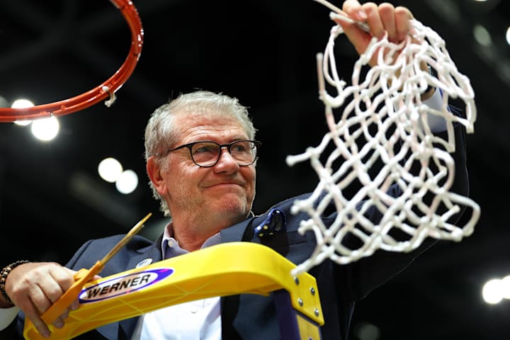 UConn head coach Geno Auriemma cuts off the net after the national championship of the women's 2025 NCAA tournament a
