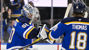 Feb 23, 2025; St. Louis, Missouri, USA;  St. Louis Blues goaltender Jordan Binnington (50) celebrates with center Robert Thomas (18) after the Blues defeated the Colorado Avalanche at Enterprise Center. Mandatory Credit: Jeff Curry-Imagn Images