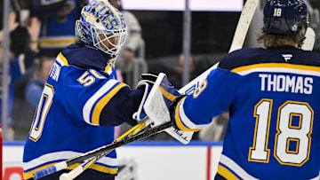 Feb 23, 2025; St. Louis, Missouri, USA;  St. Louis Blues goaltender Jordan Binnington (50) celebrates with center Robert Thomas (18) after the Blues defeated the Colorado Avalanche at Enterprise Center. Mandatory Credit: Jeff Curry-Imagn Images