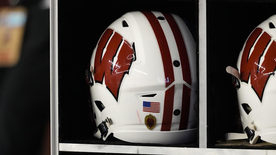 Oct 26, 2024; Madison, Wisconsin, USA;  General view of a Wisconsin Badgers helmet on the sidelines during the game against the Penn State Nittany Lions at Camp Randall Stadium. Mandatory Credit: Jeff Hanisch-Imagn Images