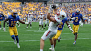 Sep 27, 2025; Pittsburgh, Pennsylvania, USA;  Louisville Cardinals tight end Nate Kurisky (85) catches a touchdown pass behind Pittsburgh Panthers defensive backs Rashad Battle (15) and Cruce Brookins (12) during the fourth quarter at Acrisure Stadium. Mandatory Credit: Charles LeClaire-Imagn Images