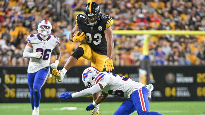 Aug 17, 2024; Pittsburgh, Pennsylvania, USA;  Pittsburgh Steelers tight end Connor Heyward (83) hurdles Buffalo Bills safety Kendall Williamson (36) during the third quarter at Acrisure Stadium. Mandatory Credit: Barry Reeger-USA TODAY Sports