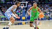 Jan 4, 2025; South Bend, Indiana, USA; Notre Dame Fighting Irish guard Markus Burton (3) dribbles as North Carolina Tar Heels guard RJ Davis (4) defends in the first half at the Purcell Pavilion. 