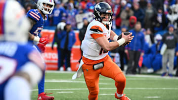 Jan 12, 2025; Orchard Park, New York, USA; Denver Broncos quarterback Bo Nix (10) runs for a gain during the fourth quarter against the Buffalo Bills in an AFC wild card game at Highmark Stadium. Mandatory Credit: Mark Konezny-Imagn Images