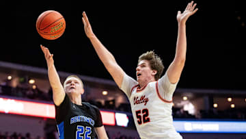 Waukee Northwest's Bode Goodman (22) shoots the ball against Valley's Trevin Jirak (52) on Friday, March 14, 2025, at Wells Fargo Arena.