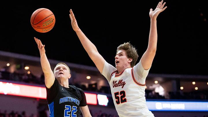 Waukee Northwest's Bode Goodman (22) shoots the ball against Valley's Trevin Jirak (52) on Friday, March 14, 2025, at Wells Fargo Arena.