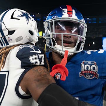 Sep 26, 2024; East Rutherford, NJ, US; New York Giants safety Tyler Nubin (31) embraces Dallas Cowboys linebacker Buddy Johnson (57) following the end of the game at MetLife Stadium.  