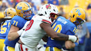 Sep 27, 2025; Pittsburgh, Pennsylvania, USA; Louisville Cardinals defensive lineman Rene Konga (90) sacks Pittsburgh Panthers quarterback Eli Holstein (10) during the fourth quarter at Acrisure Stadium. Mandatory Credit: Charles LeClaire-Imagn Images