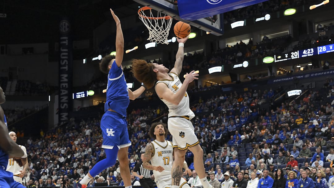 Mar 12, 2026; Nashville, TN, USA;  Missouri Tigers guard T.O. Barrett (5) lays the ball in over Kentucky Wildcats center Malachi Moreno (24) during the first half at Bridgestone Arena. Mandatory Credit: Steve Roberts-Imagn Images