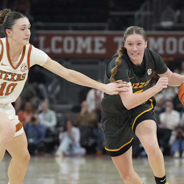 Jan 30, 2025; Austin, Texas, USA; Missouri Tigers guard Grace Slaughter (0) drives to the basket while defended by Texas Longhorns guard Shay Holle (10) during the second half at Moody Center. Mandatory Credit: Scott Wachter-Imagn Images