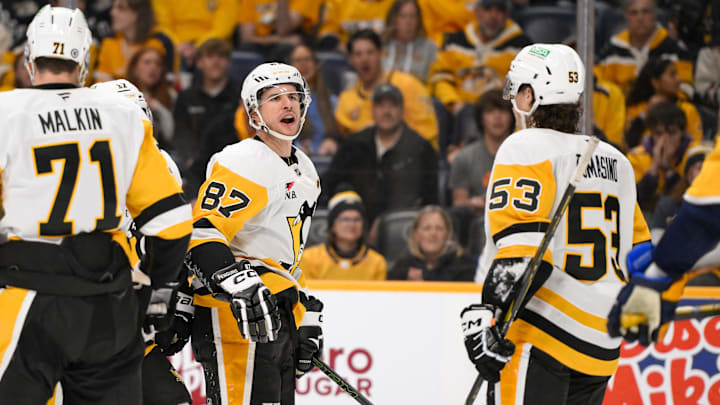 Dec 19, 2024; Nashville, Tennessee, USA;  Pittsburgh Penguins center Sidney Crosby (87) yells to Nashville Predators right wing Michael McCarron (47) after scoring his goal during the second period at Bridgestone Arena. Mandatory Credit: Steve Roberts-Imagn Images