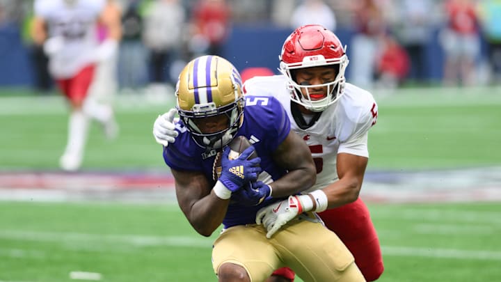 Sep 14, 2024; Seattle, Washington, USA; Washington Huskies wide receiver Giles Jackson (5) catches a pass over Washington State Cougars defensive back Tyson Durant (5) during the second half at Lumen Field. Mandatory Credit: Steven Bisig-Imagn Images