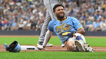 Aug 16, 2024; Milwaukee, Wisconsin, USA; Milwaukee Brewers outfielder Jackson Chourio (11) slides back to third base while be caught off base ahead of the tag by Cleveland Guardians third base José Ramírez (11) in the first inning  at American Family Field. Mandatory Credit: Michael McLoone-USA TODAY Sports