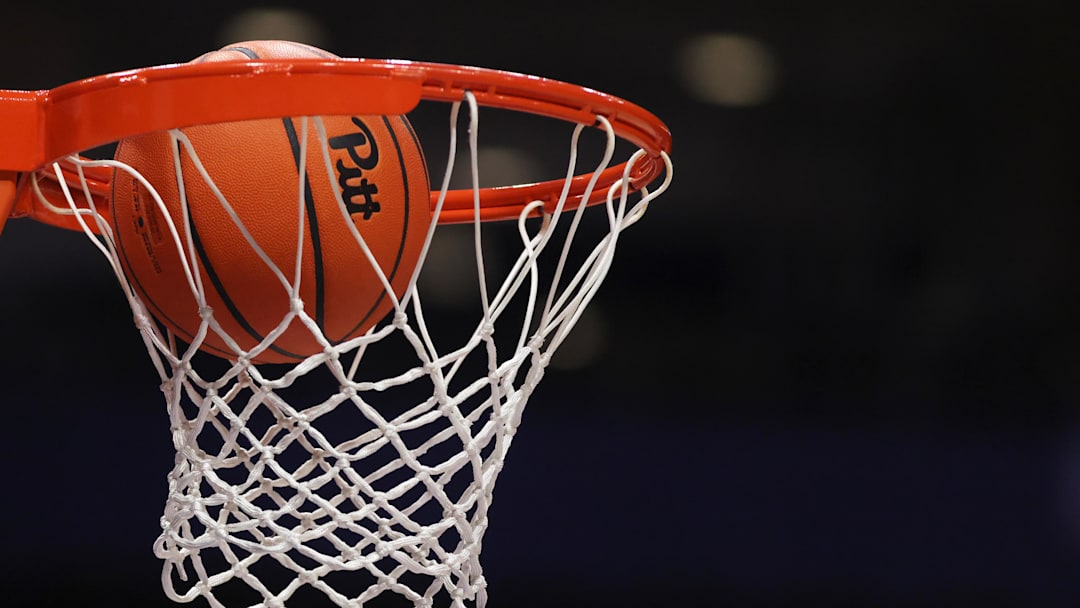 Mar 4, 2026; Pittsburgh, Pennsylvania, USA;  A Pittsburgh Panthers branded game ball goes through the net before the game against the Florida State Seminoles at the Petersen Events Center. Mandatory Credit: Charles LeClaire-Imagn Images
