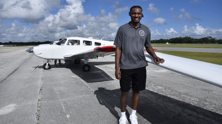 Orlando Magic center Wendell Carter Jr. poses by a plane at his "Flight 34" event on Thursday at Orlando Sanford International Airport.