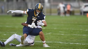 Port Huron Northern's Lincoln Watkins tries to break a tackle during a game against Warren Cousino at Memorial Stadium in Port Huron on Friday, Sept. 20, 2024.