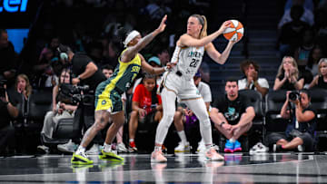 Jul 6, 2025; Brooklyn, New York, USA; New York Liberty guard Sabrina Ionescu (20) looks to pass the ball as Seattle Storm guard Erica Wheeler (17) defends during the first half at Barclays Center. Mandatory Credit: John Jones-Imagn Images