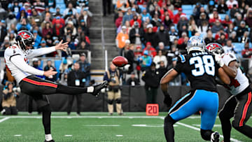 Dec 1, 2024; Charlotte, North Carolina, USA;  Tampa Bay Buccaneers punter Trenton Gill (16) punts in the second quarter at Bank of America Stadium. Mandatory Credit: Bob Donnan-Imagn Images