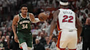Apr 24, 2023; Miami, Florida, USA; Milwaukee Bucks forward Giannis Antetokounmpo (34) brings the ball up the court as Miami Heat forward Jimmy Butler (22) defends in the first quarter during game four of the 2023 NBA Playoffs at Kaseya Center. Mandatory Credit: Jim Rassol-Imagn Images