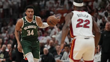 Apr 24, 2023; Miami, Florida, USA; Milwaukee Bucks forward Giannis Antetokounmpo (34) brings the ball up the court as Miami Heat forward Jimmy Butler (22) defends in the first quarter during game four of the 2023 NBA Playoffs at Kaseya Center. Mandatory Credit: Jim Rassol-Imagn Images