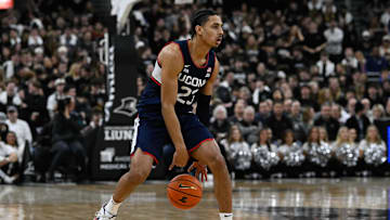 Mar 1, 2025; Providence, Rhode Island, USA; Connecticut Huskies forward Jayden Ross (23) dribbles against the Providence Friars  during the first half at Amica Mutual Pavilion. Mandatory Credit: Eric Canha-Imagn Images