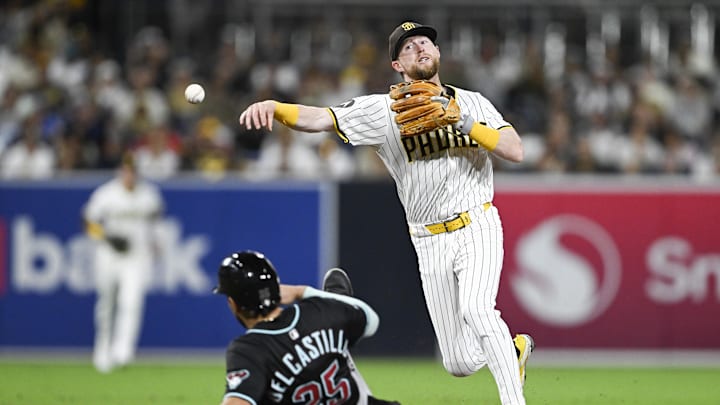 Sep 27, 2025; San Diego, California, USA; San Diego Padres second baseman Jake Cronenworth (9) throws over Arizona Diamondbacks catcher Adrian Del Castillo (25) as he turns a double play during the fifth inning at Petco Park. Mandatory Credit: Denis Poroy-Imagn Images