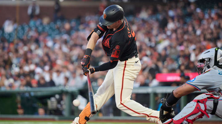 Aug 31, 2024; San Francisco, California, USA; San Francisco Giants outfielder Mike Yastrzemski (5) hits into an RBI fielders choice against the Miami Marlins during the fifth inning at Oracle Park. 