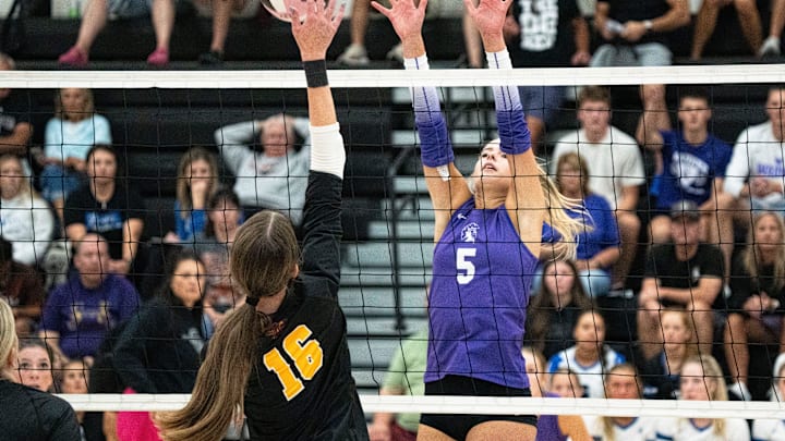 Ankeny's Hailey Wiederin spikes the ball against Waukee's Mia Heinrich during a tournament at Ankeny Centennial High School on Aug. 30, 2025, in Ankeny.