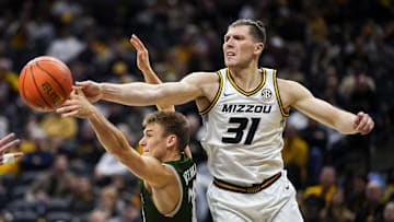 Nov 25, 2023; Columbia, Missouri, USA; Loyola (Md) Greyhounds guard Chris Kuzemka (20) and Missouri Tigers guard Caleb Grill (31) fight for a rebound during the second half at Mizzou Arena. Mandatory Credit: Jay Biggerstaff-Imagn Images