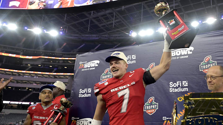 Dec 18, 2024; Inglewood, CA, USA; RUNLV Rebels linebacker Jackson Woodard (7) holds his defensive player of the game trophy as wide receiver Jacob De Jesus (21) was named offensive player of the game after defeating the California Golden Bears in the LA Bowl at SoFi Stadium. Mandatory Credit: Jayne Kamin-Oncea-Imagn Images Dec 18, 2024; Inglewood, CA, USA; RUNLV Rebels linebacker Jackson Woodard (7) holds his defensive player of the game trophy as wide receiver Jacob De Jesus (21) was named offensive player of the game after defeating the California Golden Bears in the LA Bowl at SoFi Stadium. Mandatory Credit: Jayne Kamin-Oncea-Imagn Images